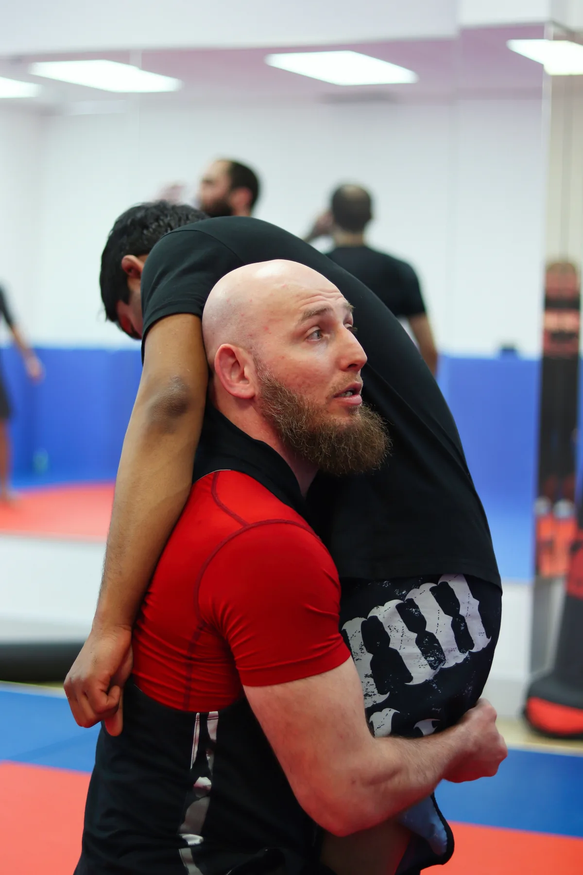 A wrestler securing a body lock during takedown training